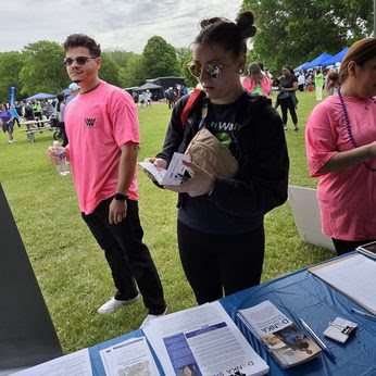 A lady reads a Donka pamphlet