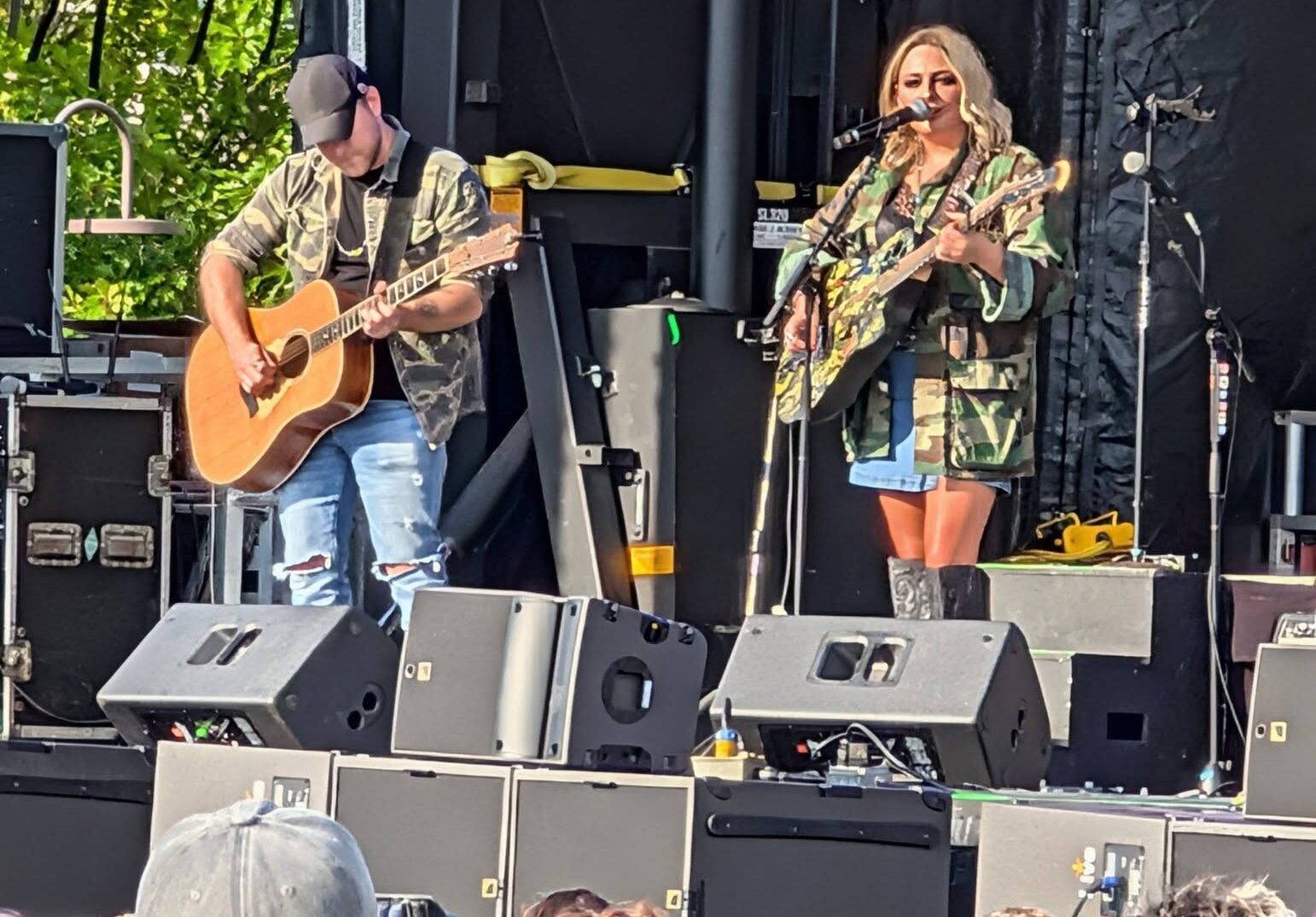 Hunter Girl playing guitar on stage with man playing guitar